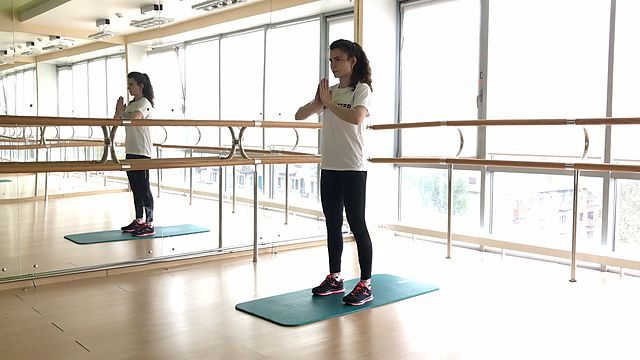 Photo of Squeezing hands in front of chest exercise