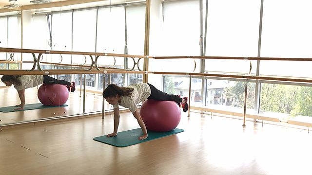 Photo of Stepping hands lying on a fitball exercise