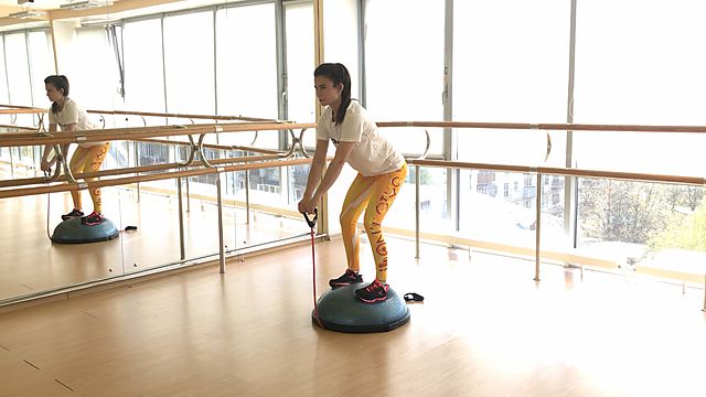 Photo of Raising straight arms on bosu with resistance band exercise