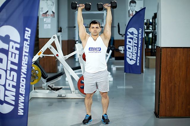 Photo of Standing Dumbbell Press exercise