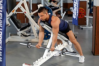 Barbell Curls Lying Against An Incline