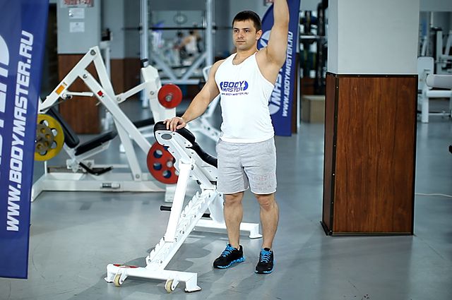 Photo of Standing Palm-In One-Arm Dumbbell Press exercise